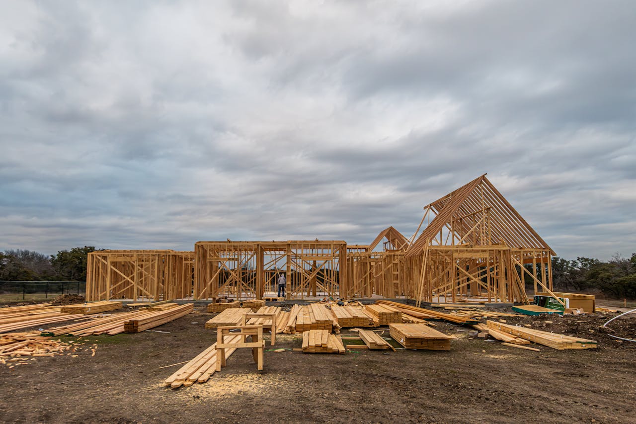 Wooden house framing under construction in Fort Worth, TX during a cloudy day.